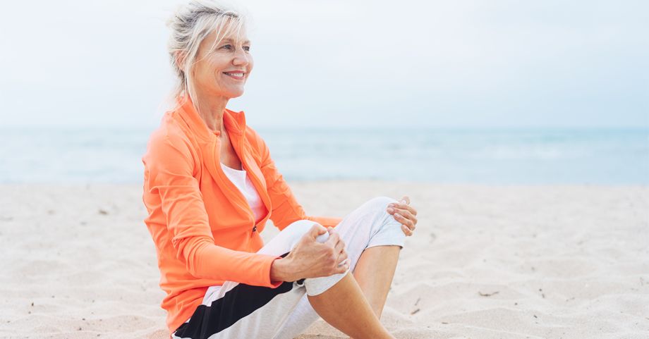 Happy and healthy physically fit older woman, focus on abdomen and aging gracefully