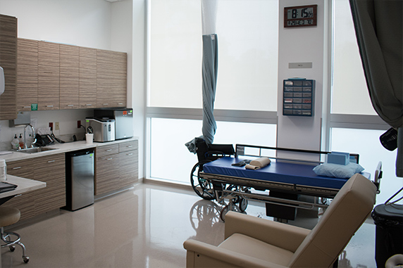 Tastefully designed room with gurney and recliner